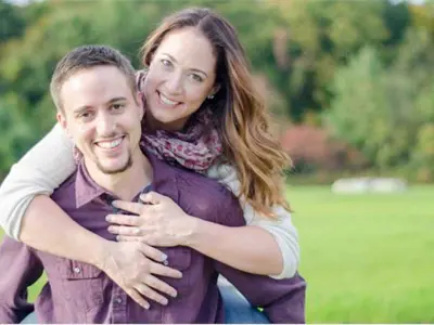 couple embracing and smiling at camera