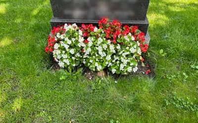 Flowers in front of gravestone