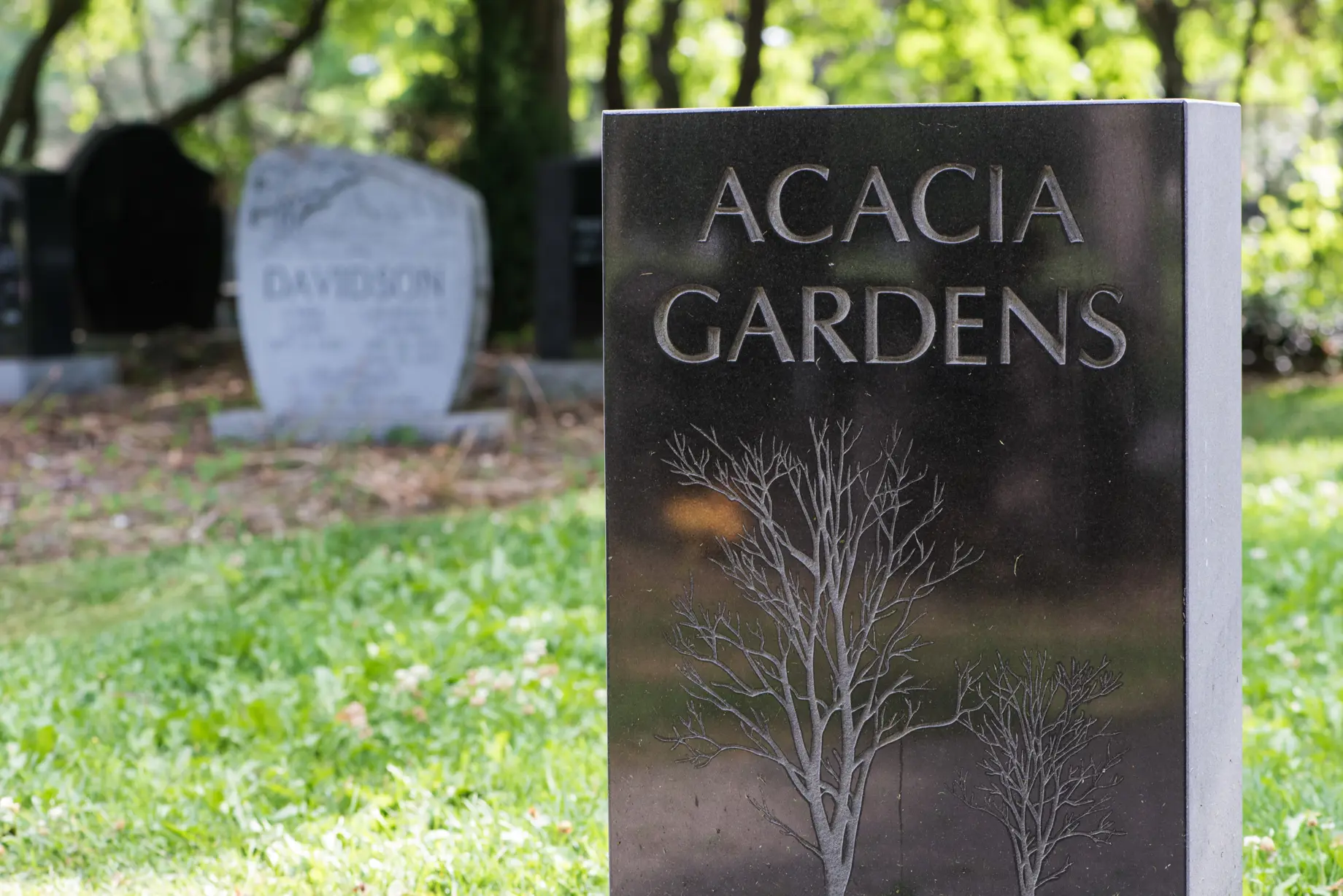Tombstone that says Acacia Gardens
