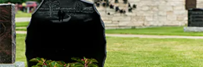 gravestone with flowerbed in front of it