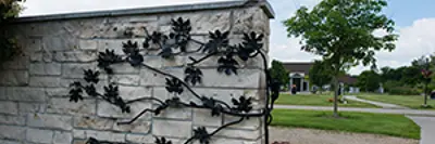 stone fence with mental floral decor