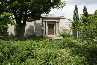 mausoleum with greenery in front of it