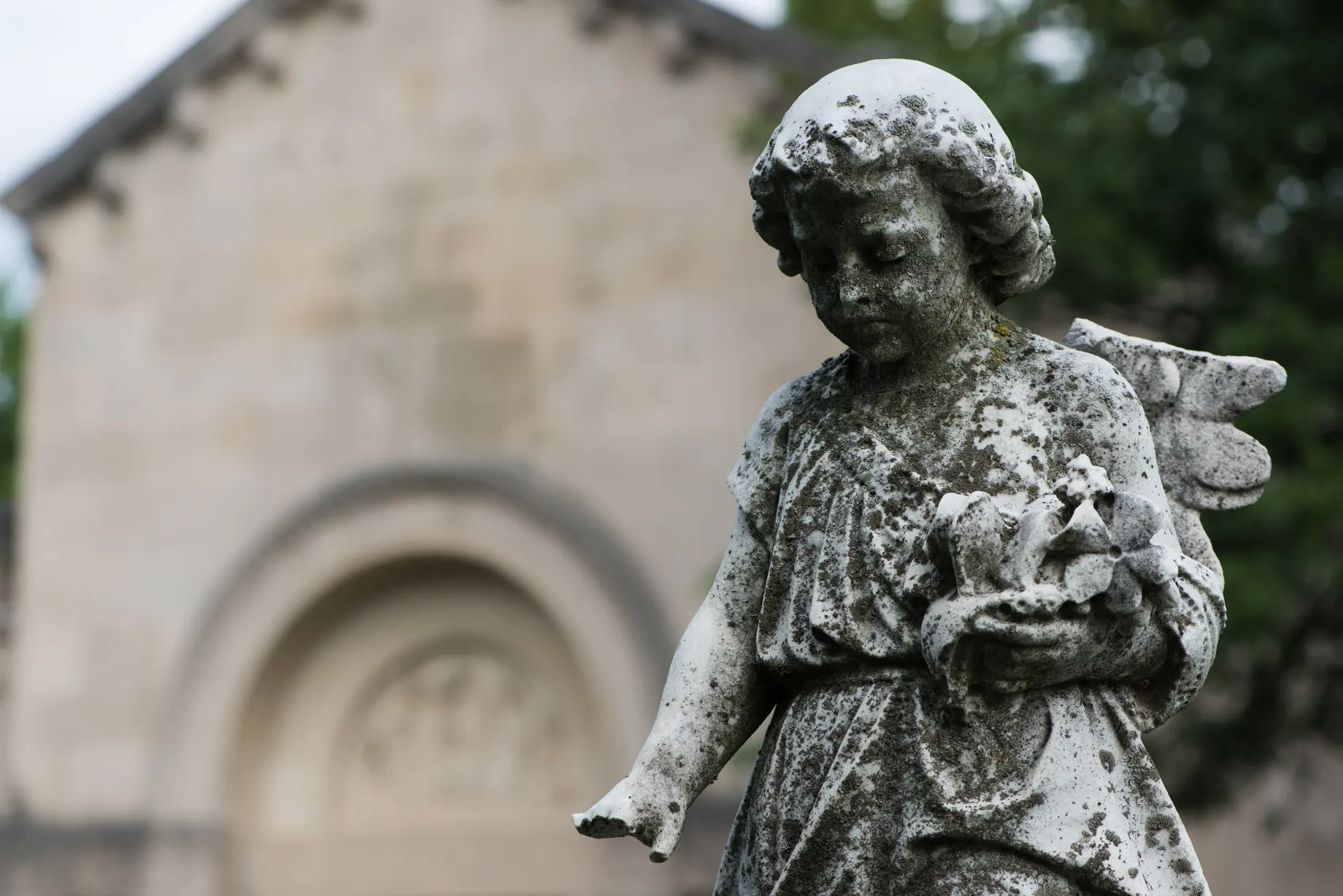 angel statue with mausoleum in background