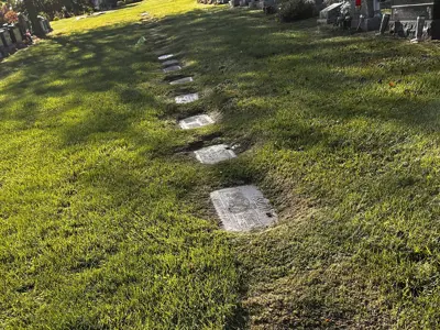 grave flat markers in grass